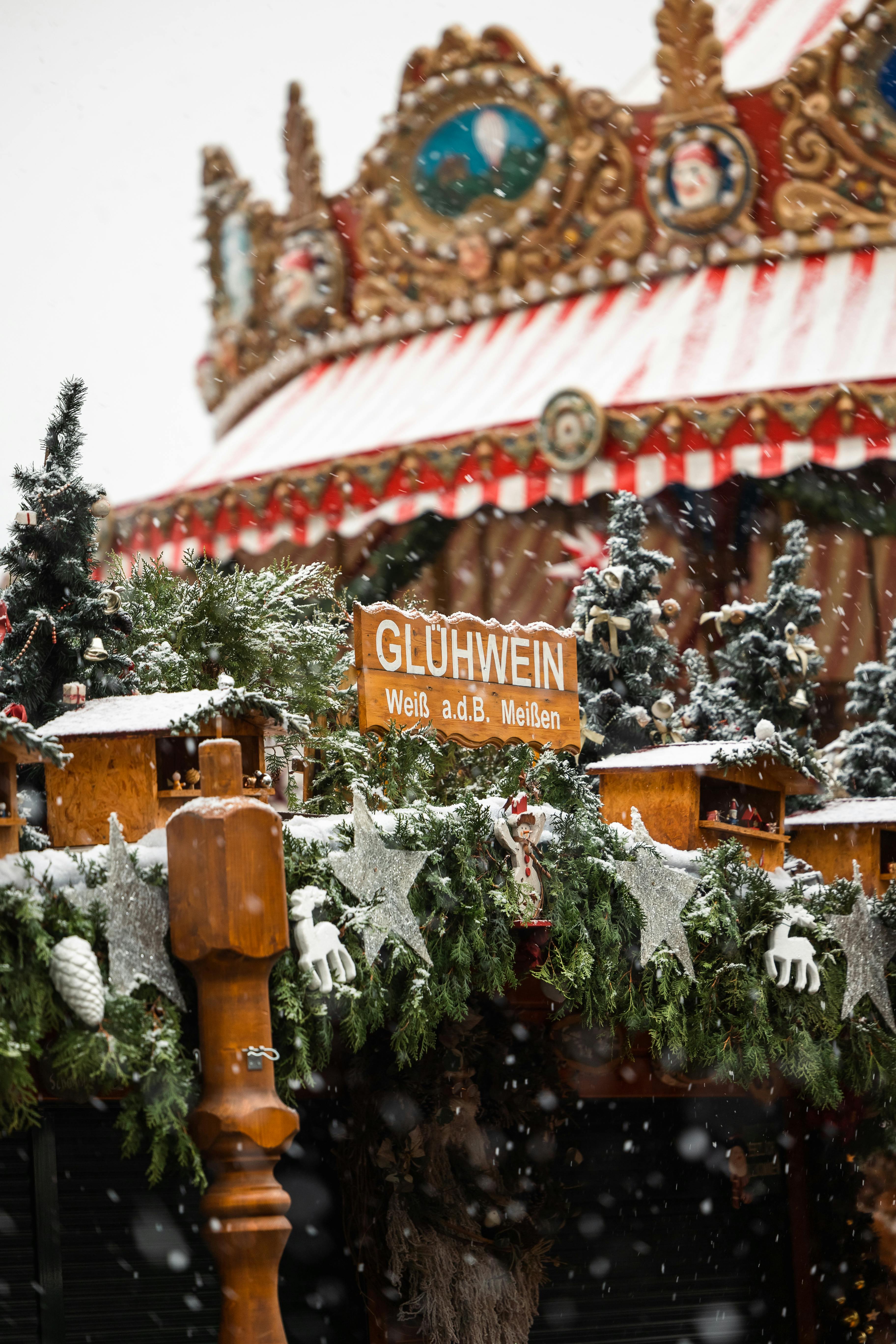 carousel and mulled wine sign in christmas market in dresden