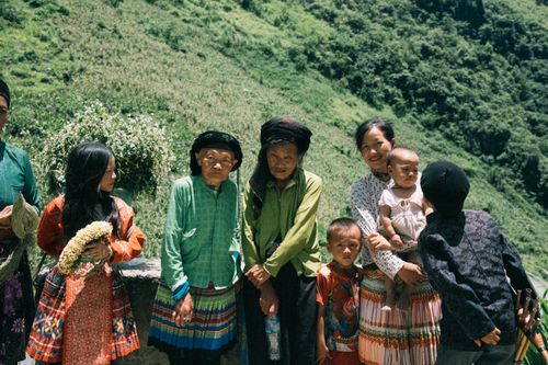 Free A group of Asian family members in traditional clothing standing outdoors in a rural landscape. Stock Photo