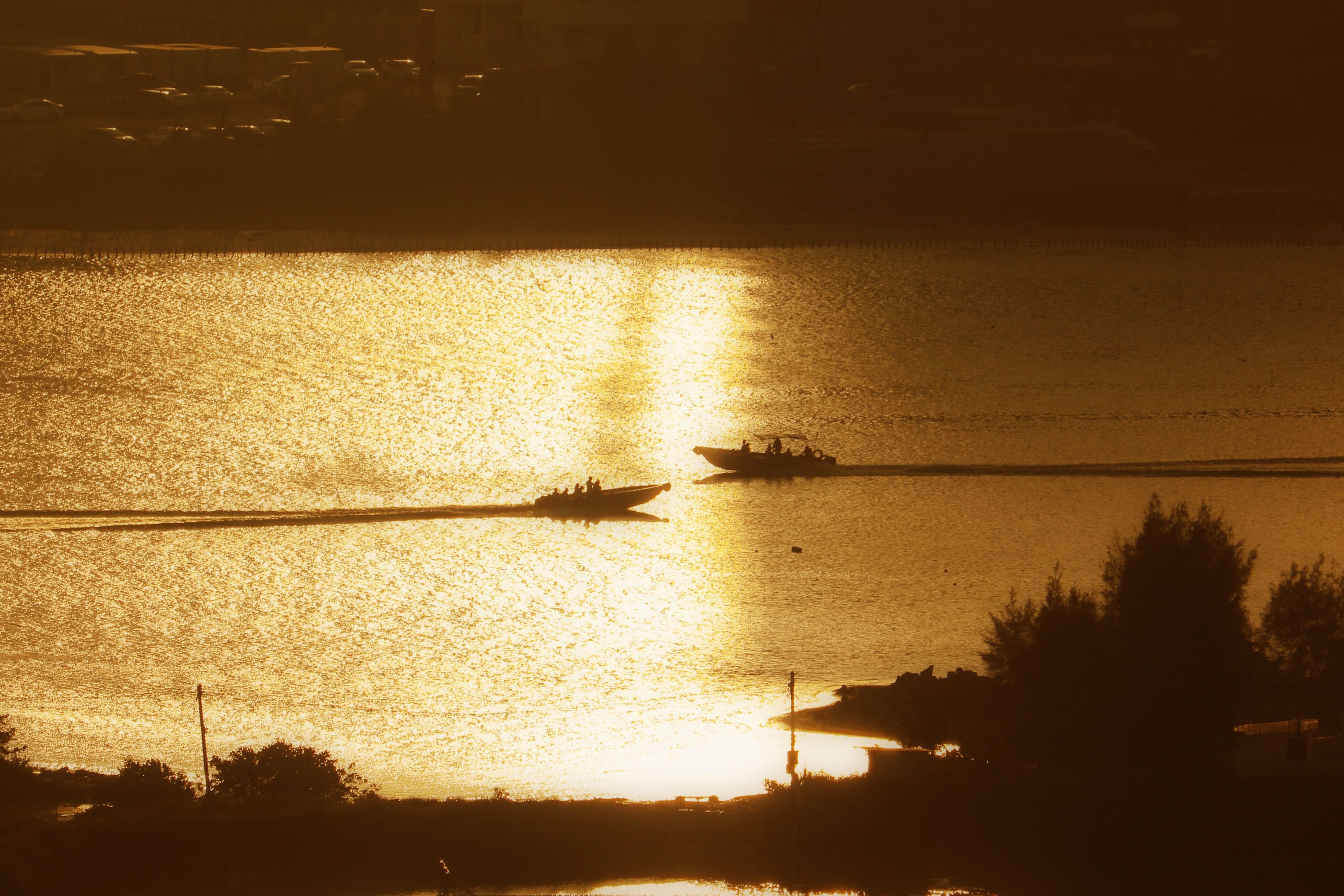 View of Silhouetted Boat on a Body of Water in the Evening · Free Stock ...