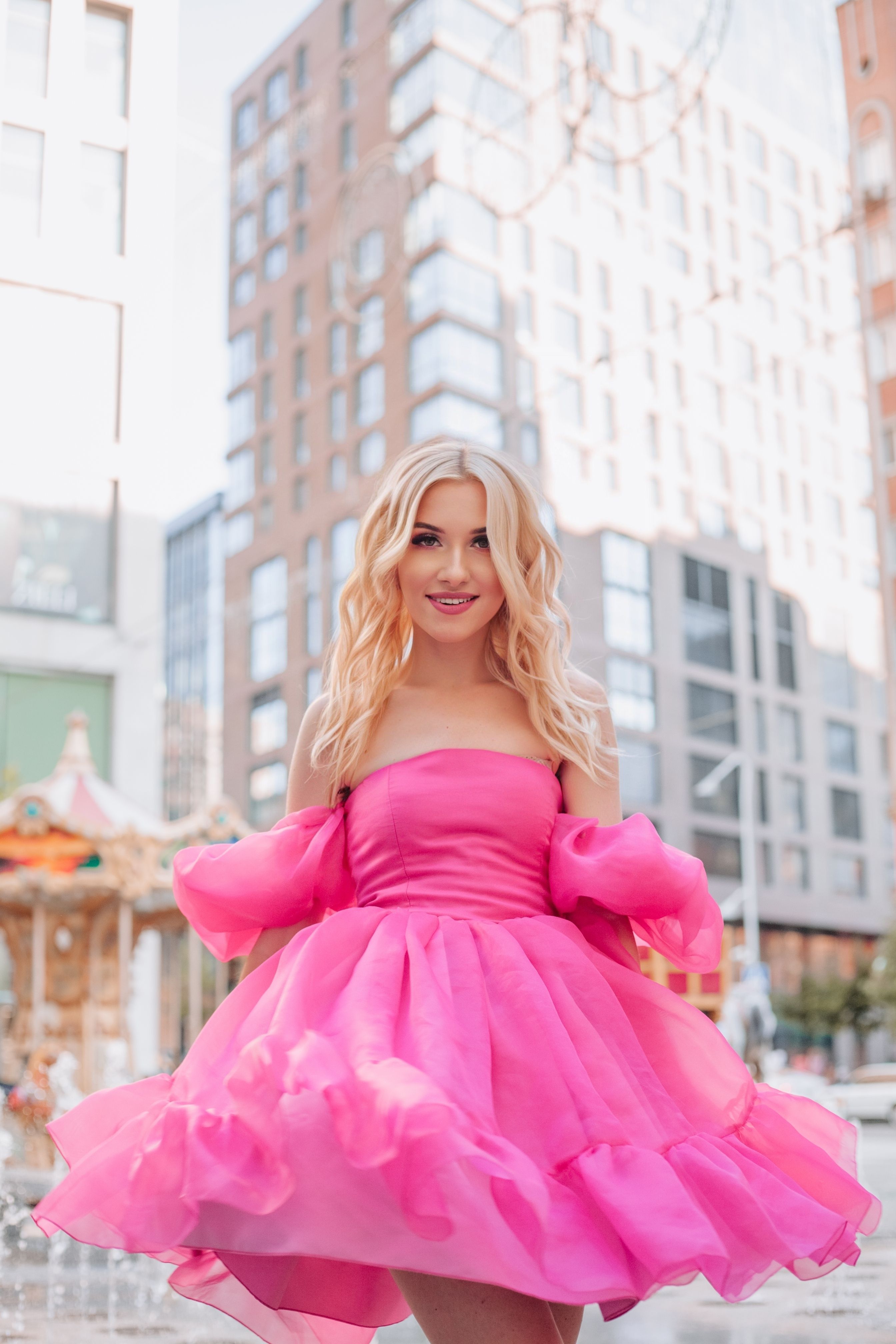 A blonde woman in a pink dress posing for a photo · Free Stock Photo