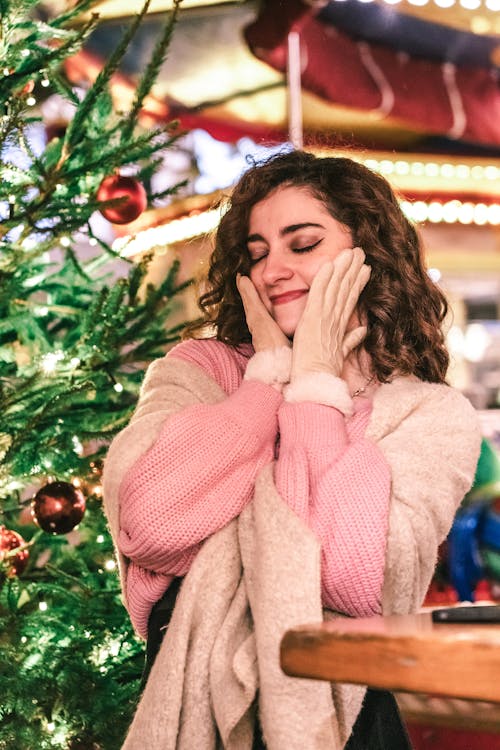 Brunette Woman Next to a Christmas Tree