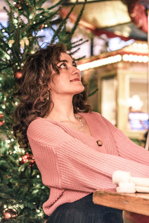 Brunette Woman Next to a Christmas Tree