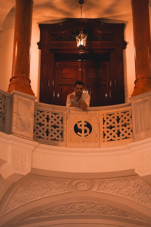 Free Man posing on marble mezzanine balcony in an elegant interior setting in Ankara, Türkiye. Stock Photo