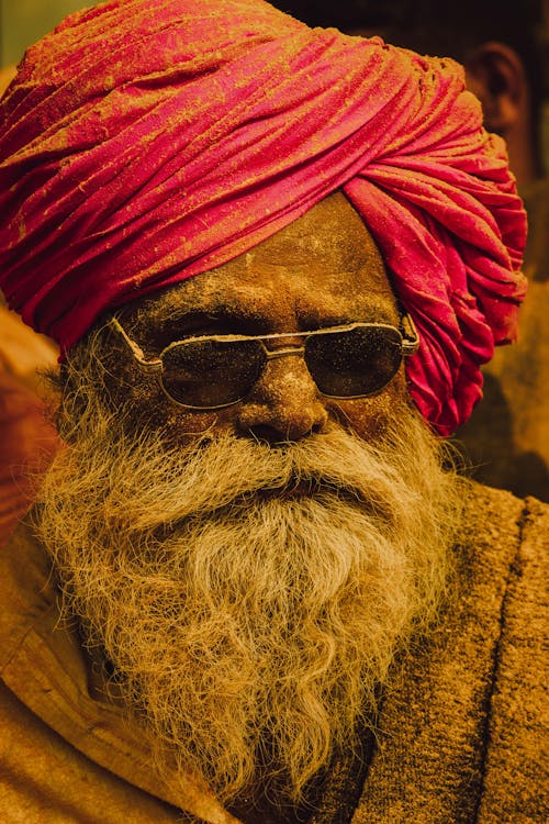 Close-up Portrait of an Elderly Bearded Man Wearing a Turban and Sunglasses 