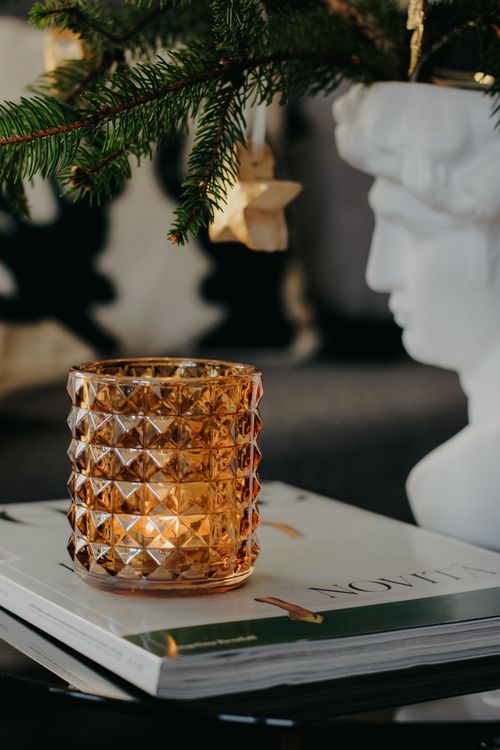 Free Stylish decor with a candle and holiday elements on a coffee table. Stock Photo