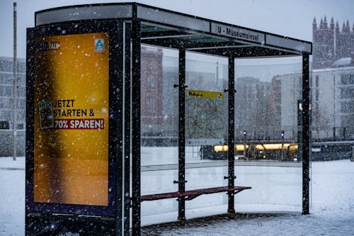 Empty Bus Stop on Snow Covered Street