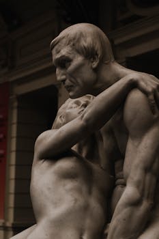 A close-up of a romantic marble sculpture depicting two figures embracing, showcasing classical artistry.