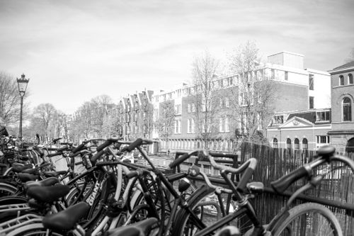 Free Classic black and white view of bicycles along Amsterdam canal. Iconic urban landscape. Stock Photo