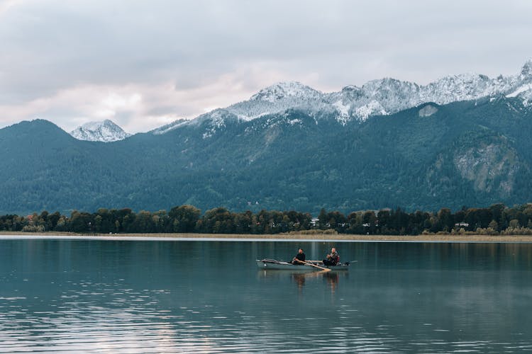 Man Paddling On Alpsee In Germany