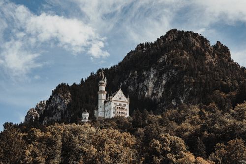 Free Stunning view of Neuschwanstein Castle nestled in the lush Bavarian Alps. Stock Photo