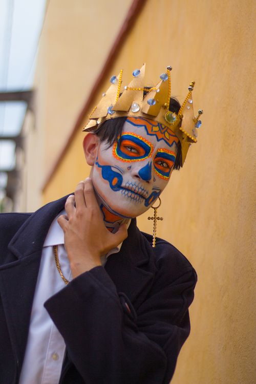 Free Colorful Day of the Dead face paint on a man with a decorative crown, vibrant and cultural. Stock Photo