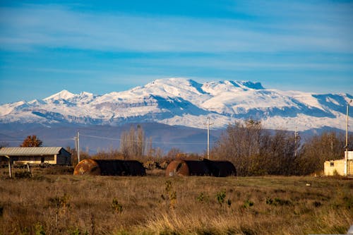 Rural Grassland and Mountains in Snow behind