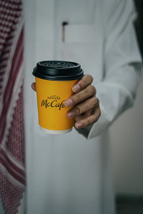 Hand Holding Paper Coffee Cup