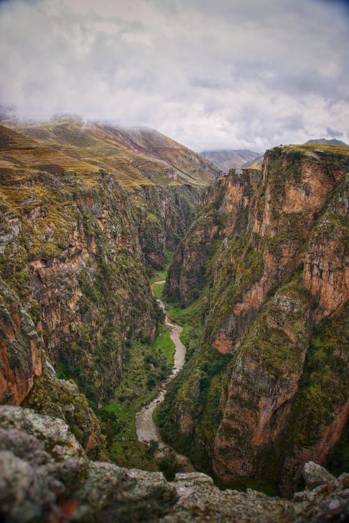 Free Breathtaking high-angle shot of a deep canyon with cliffs and a winding river. Stock Photo