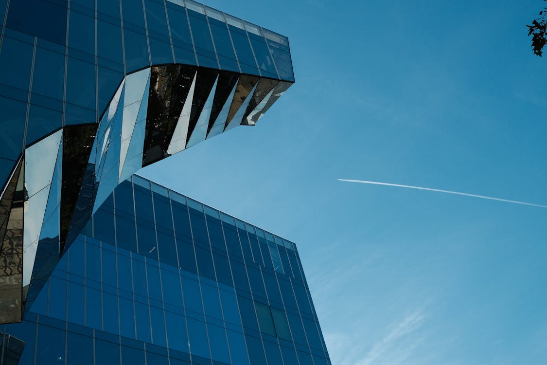 Low Angle Shot of a Modern Skyscraper in City under Blue Sky 