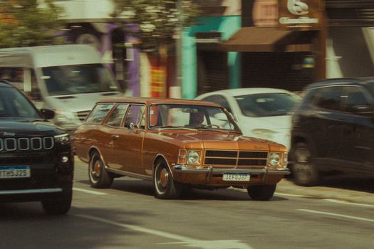 Retro car on a busy city street, showcasing urban transportation vibe.