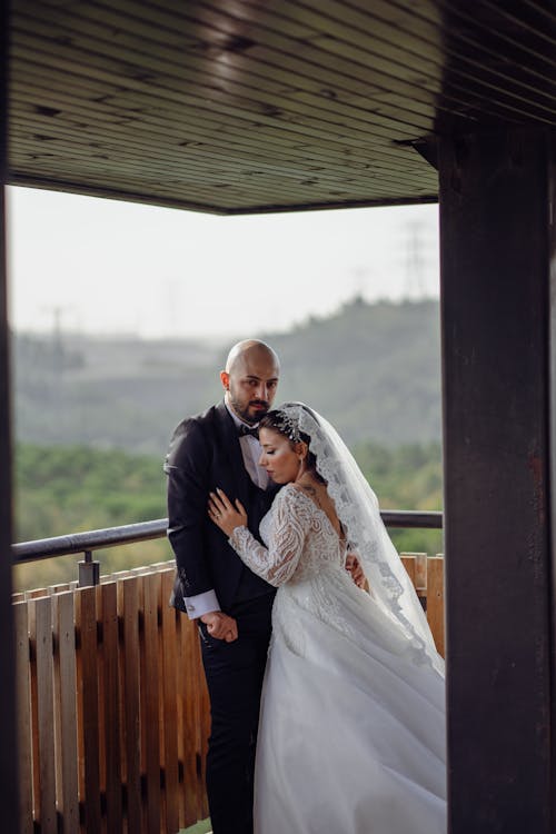 Newlyweds Standing Together and Hugging