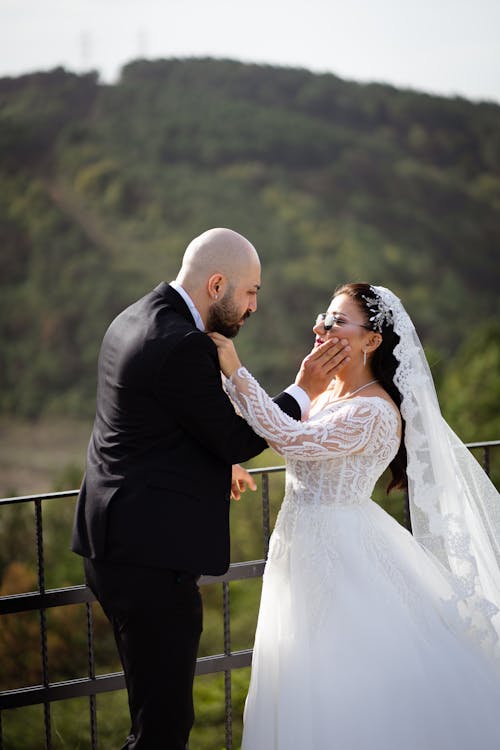 Newlyweds Standing Together and Touching each other