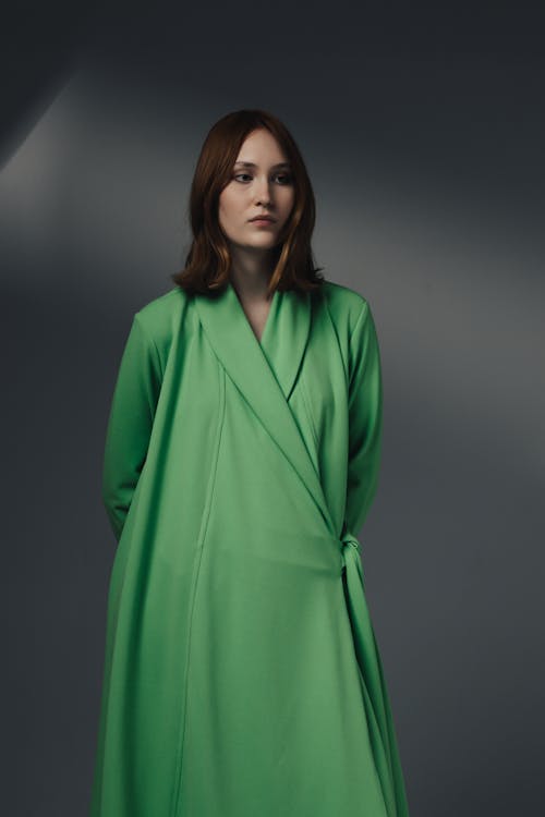 Woman Standing in Green Clothes
