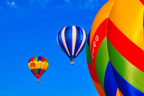 Colorful Hot Air Balloons Flying against Blue Sky 