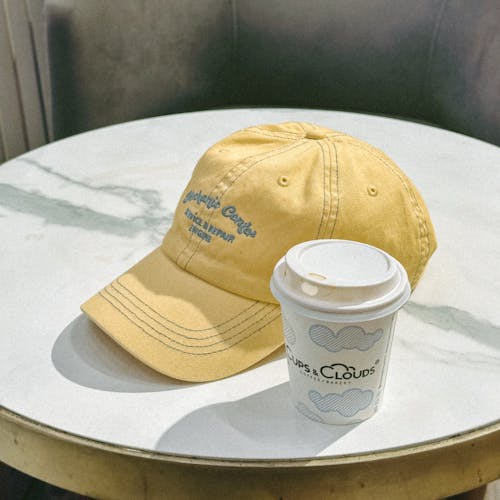 A Cap and a Cup of Coffee on the Table 