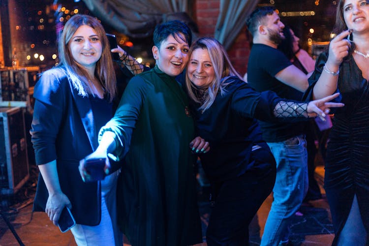 A Group Of Women Dancing In A Nightclub 