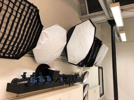 Image of a modern photography studio with lighting equipment and softboxes on display. - Fotografer Sidoarjo