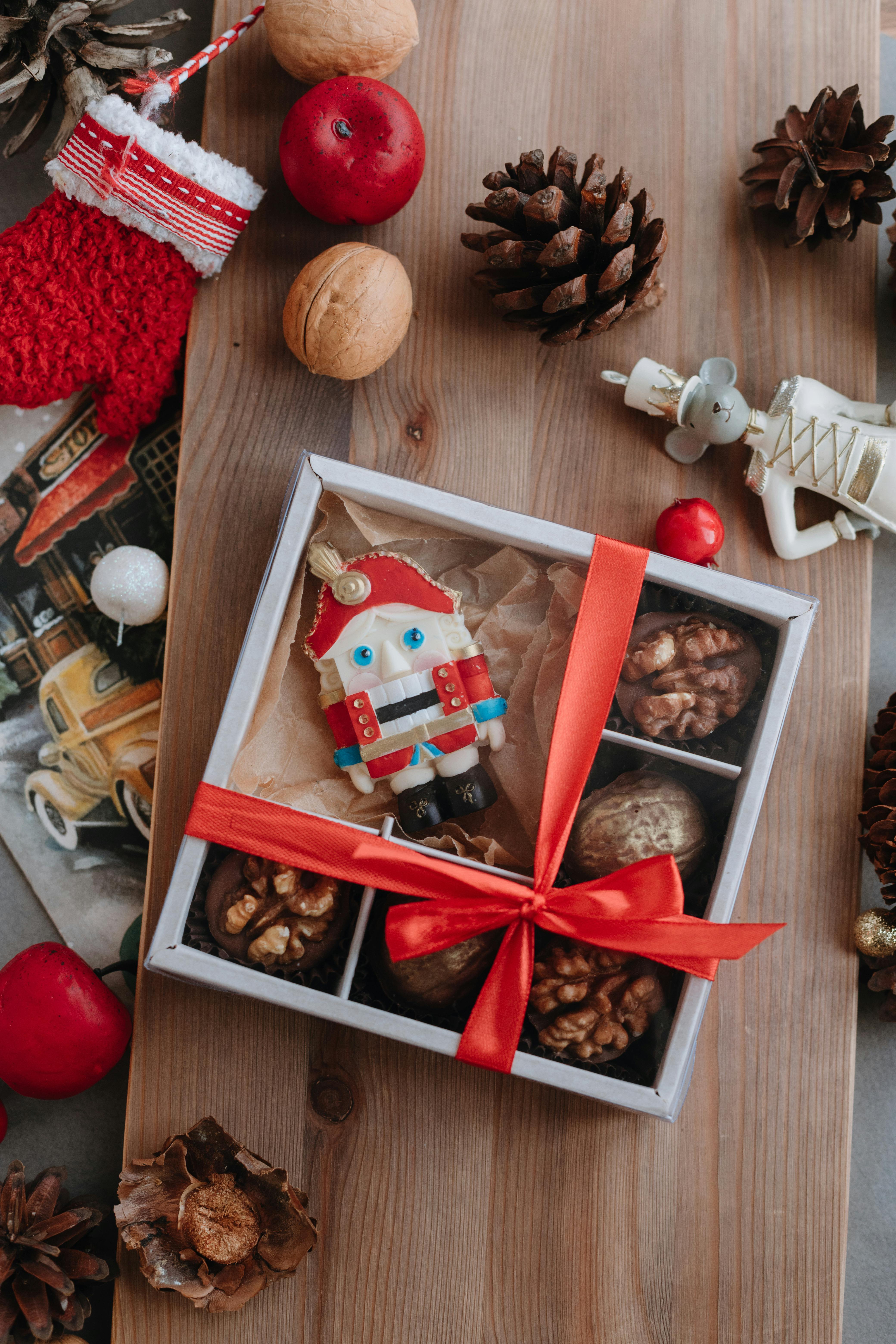 doll and chocolates in box with ribbon