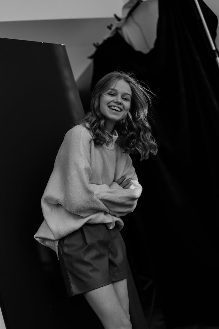 Smiling Woman Standing With Arms Crossed