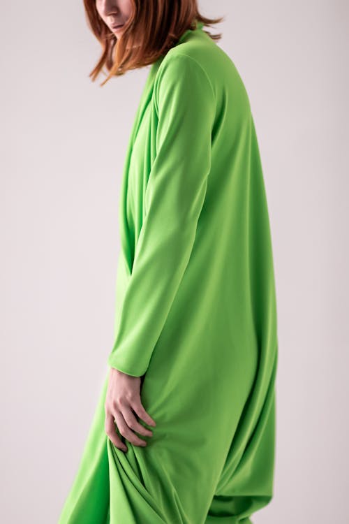 Woman Standing in Green Clothes