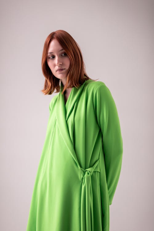 Young Woman Posing in Studio in a Green Dress 