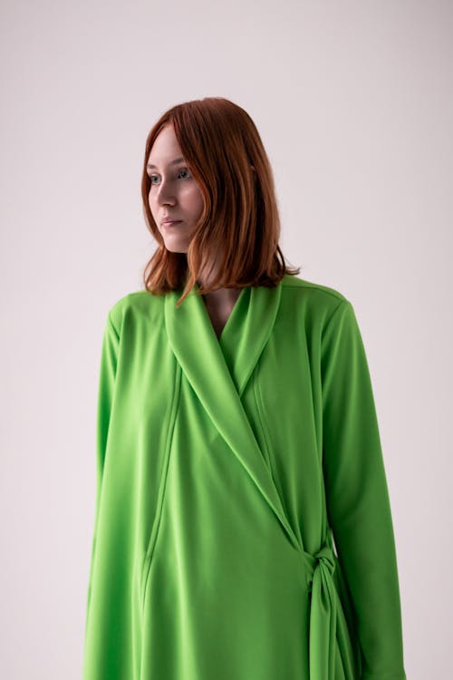 Young Woman Posing in Studio in a Green Dress 