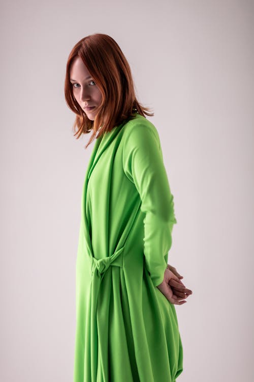 Young Woman Posing in Studio in a Green Dress 