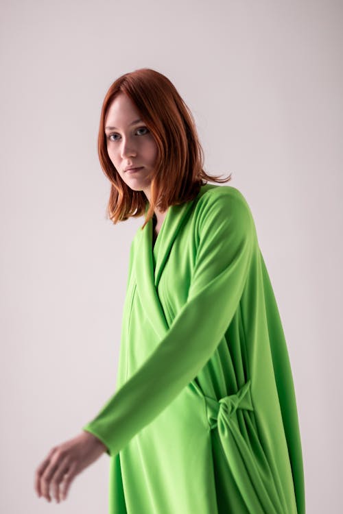 Young Woman Posing in Studio in a Green Dress 