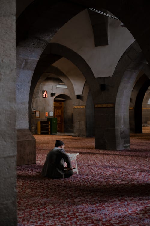 Man Sitting in a Mosque 