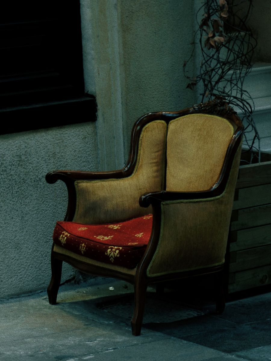 A vintage armchair with floral upholstery fabric, the kind of piece brought back to life through custom reupholstery.