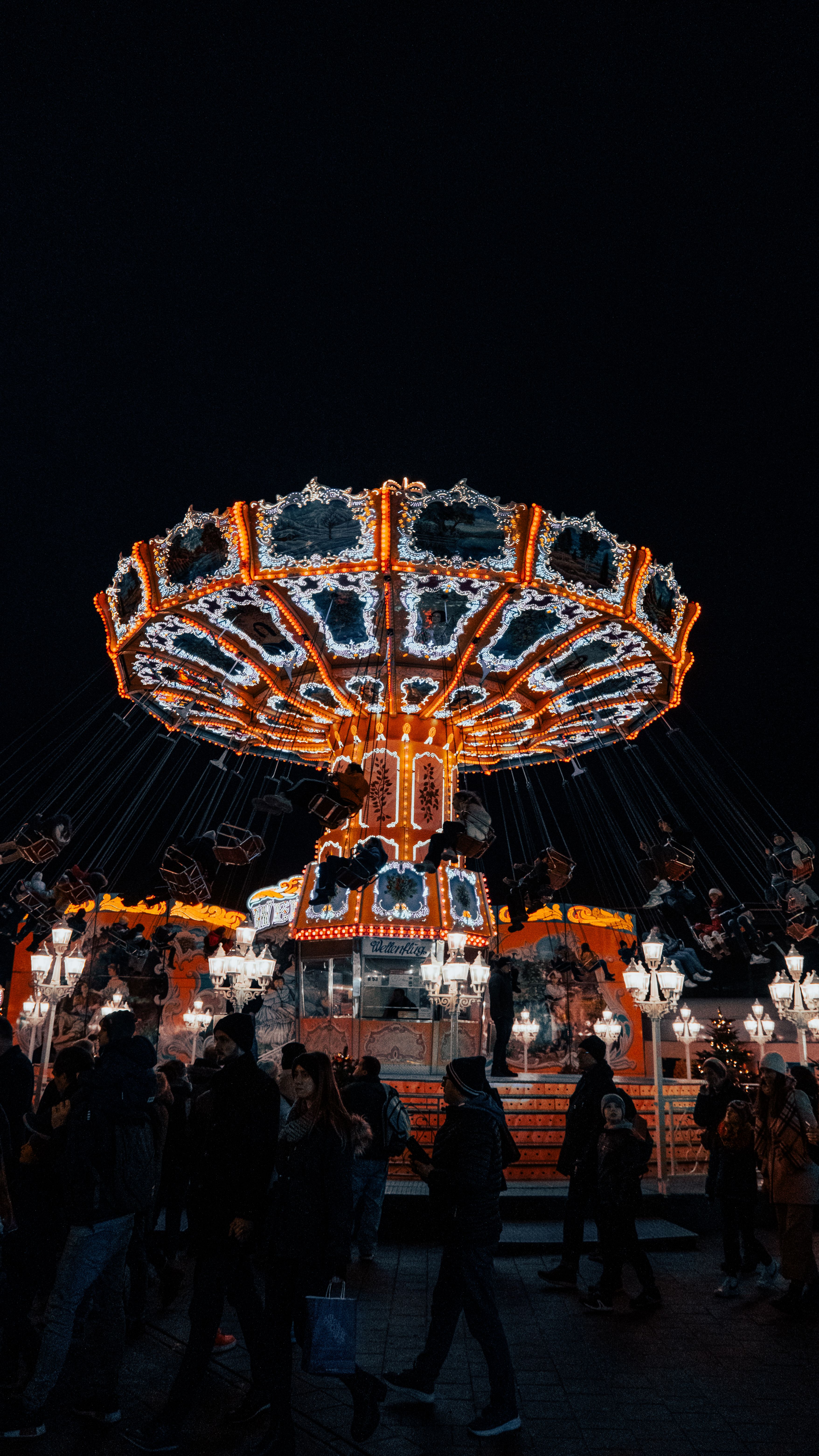 A carnival ride at night with people on it · Free Stock Photo