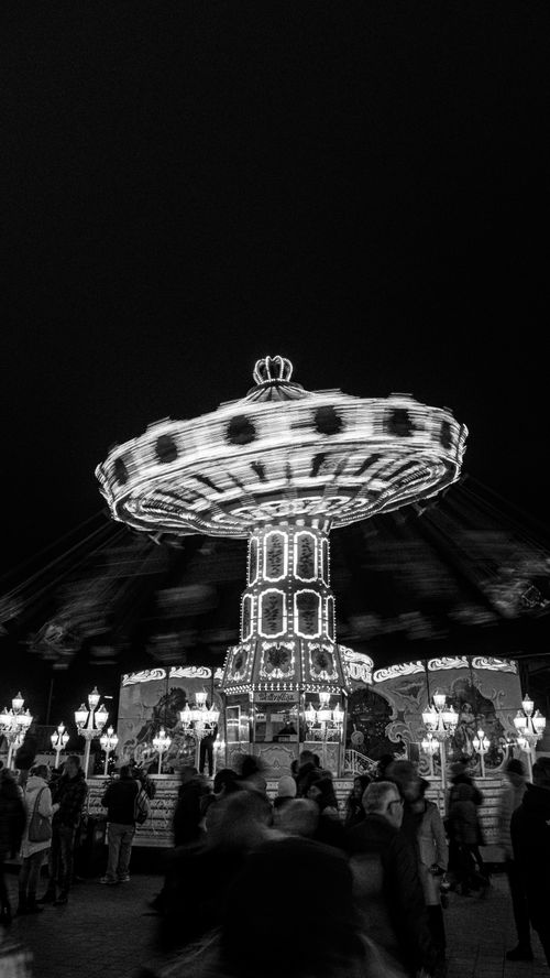 Free Illuminated carousel at night in Hamburg, Germany capturing the festive atmosphere. Stock Photo