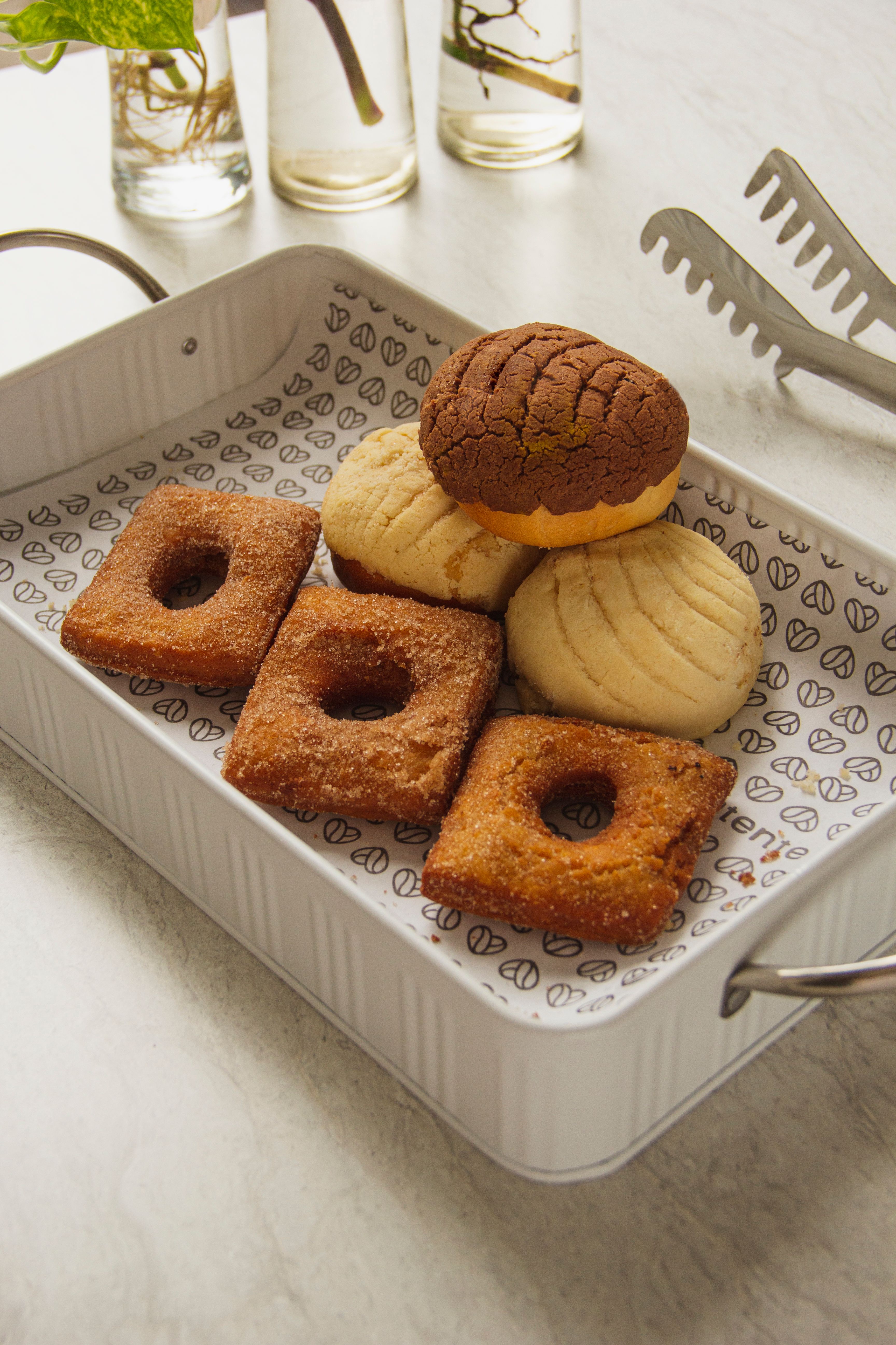 A selection of traditional Mexican pastries displayed in a decorative tray, perfect for dessert lovers.