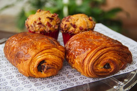 Freshly baked pastries including croissants and muffins from a León bakery.