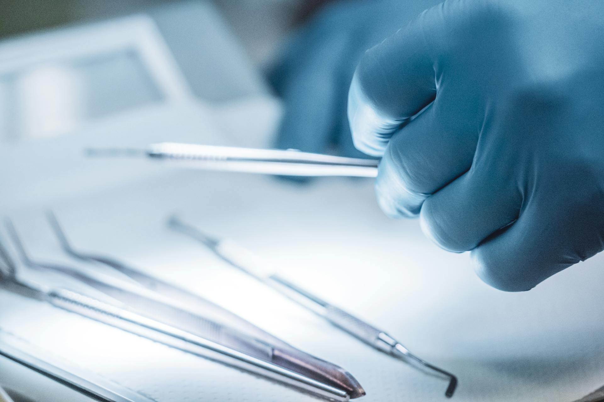 Close-up of a Surgeon Holding Steel Medical Instruments