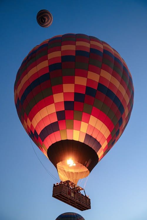 Low Angle Shot of a Flying Colorful Hot Air Balloon