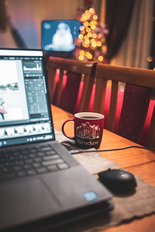 Laptop, Mouse and Cup on Table