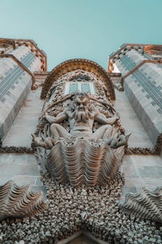 Low angle view of intricate sculpture on Pena Palace facade in Sintra, Portugal.