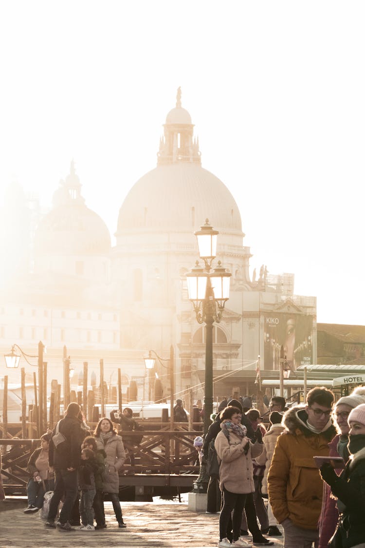 A Crowd Walking On The Streets Of Venice On The Background Of Santa Maria Della Salute Basilica