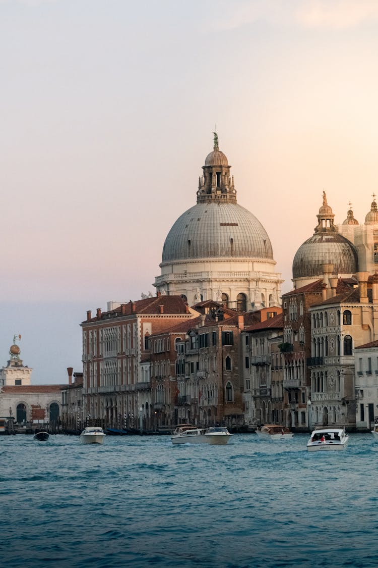 Santa Maria Della Salute Basilica And Boats On Canal Grande In Venice, Italy