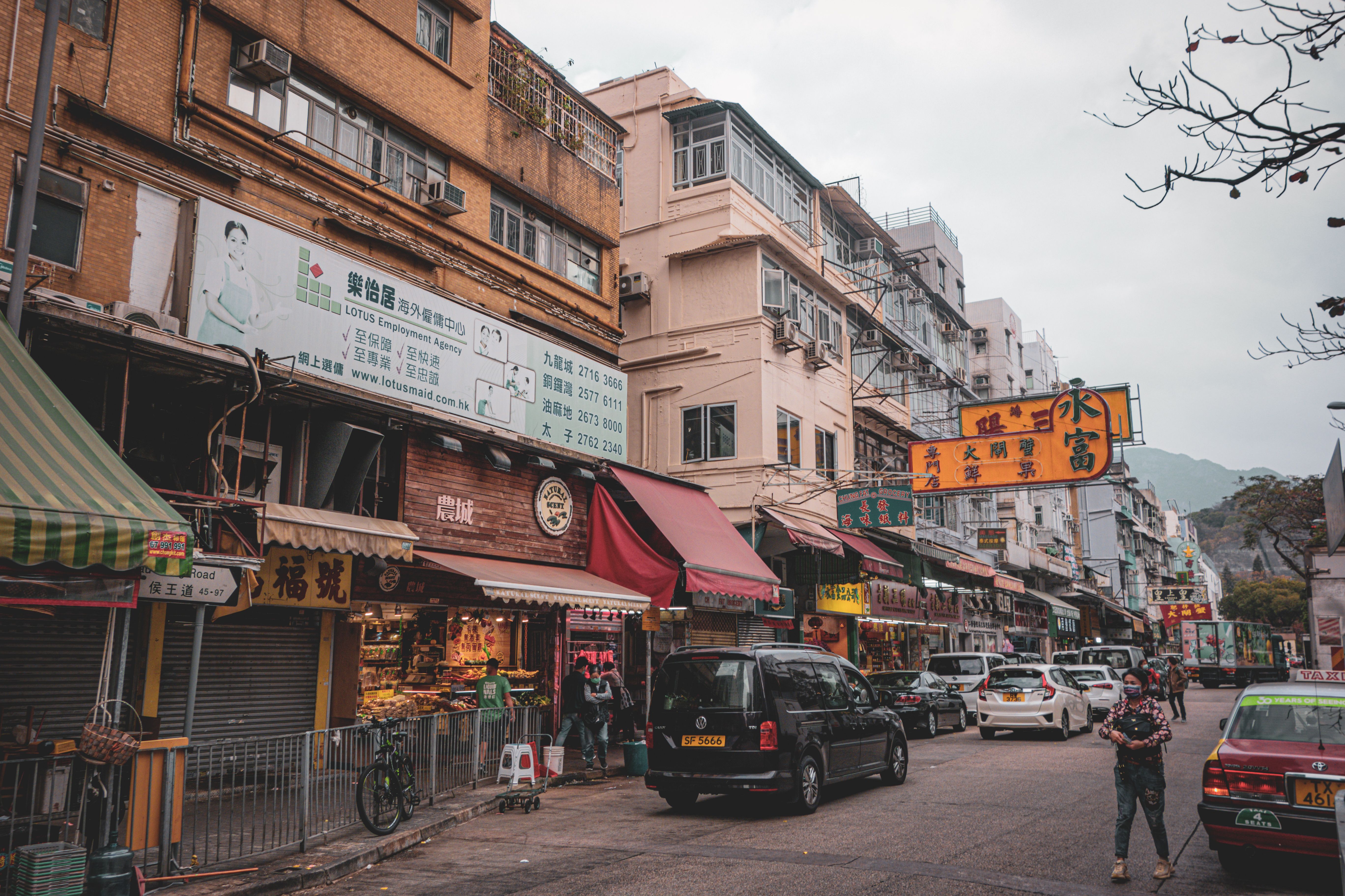 Lively street market scene in Hong Kong with bustling activities and vibrant signage capturing urban essence.
