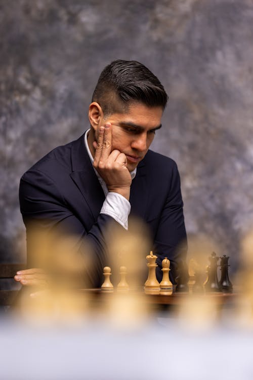 Man in Suit Thinking over Chess