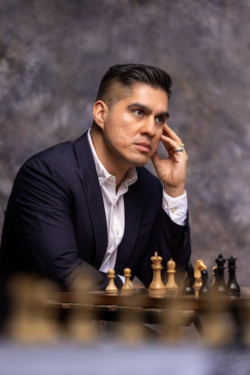 Man in Suit Thinking over Chess