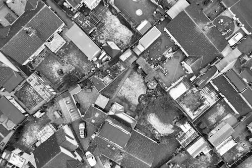 Aerial View of Snow Covered Yards and Rooftops of Tightly Packed Houses